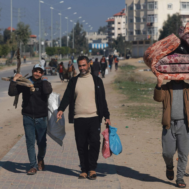 People carrying some of their belongings arrive in Rafah on the southern Gaza Strip on January 4, 2024, after fleeing from Khan Yunis amid continuing battles between Israel and the Palestinian militant group Hamas. (Photo by MOHAMMED ABED/AFP)