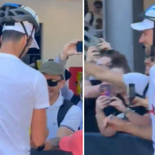 Đoković potpisuje autograme s kacigom na glavi