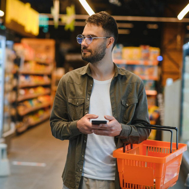 Handsome man shopping in a supermarket.