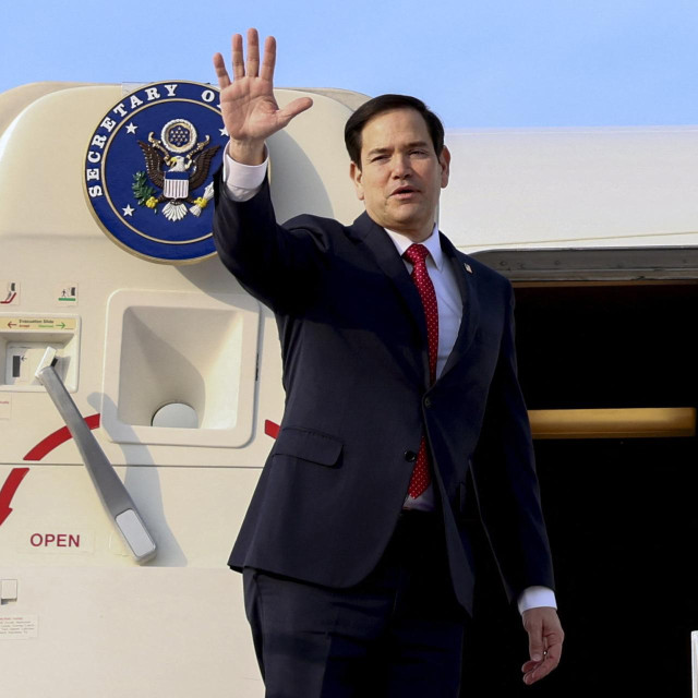 US Secretary of State Marco Rubio waves while boarding an aircraft to travel to Abu Dhabi, in Riyadh, Saudi Arabia, on February 19, 2025. (Photo by Evelyn Hockstein/POOL/AFP)