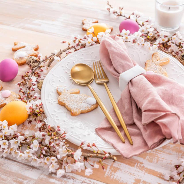 Easter table setting with colorful eggs and homemade bunny cookies