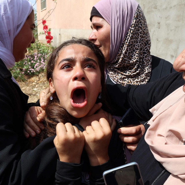Rodbina tješi djevojku na pogrebu palestinske žrtve ubijene tijekom izraelskog napada