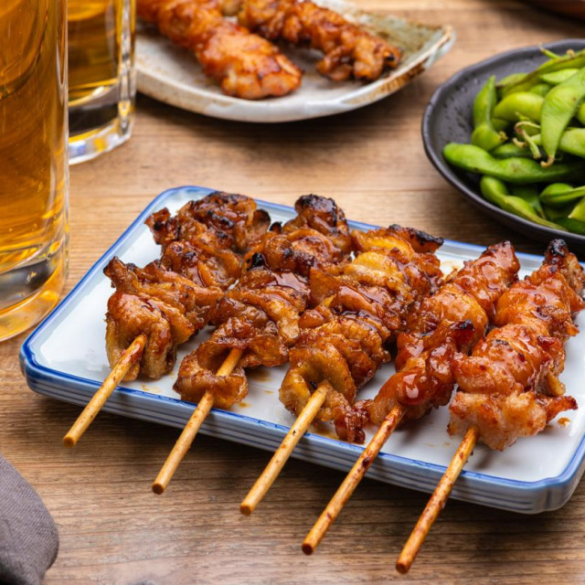 Yakitori, Dishes, and Beer on Izakaya Table