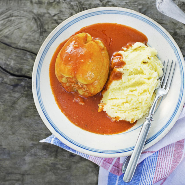 Stuffed peppers with ground meat and rice in tomato sauce with mashed potatoes. European traditional dish cuisine