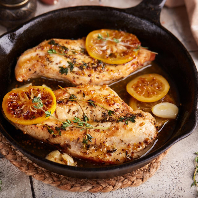Chicken breast meat fillet roasted with thyme, lemon and mustard sauce. Delicious homemade poultry dish