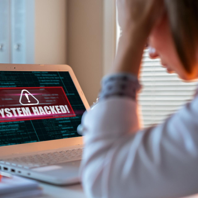 Worried woman looking at laptop. Internet fraud concept.