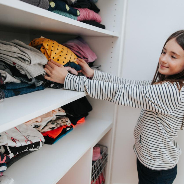 teen girl picking an outfit to wear