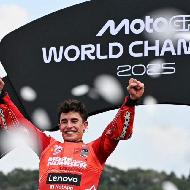 TOPSHOT - Ducati Lenovo Team‘s Spanish MotoGP rider Marc Marquez celebrates on the podium after the MotoGP class race of the MotoGP Japanese Grand Prix at the Mobility Resort Motegi in Motegi, Tochigi prefecture on September 28, 2025. An emotional Marc Marquez clinched his seventh MotoGP world championship and his first since 2019 after finishing second at the Japan grand prix, with Francesco Bagnaia winning the race. (Photo by Toshifumi KITAMURA/AFP)