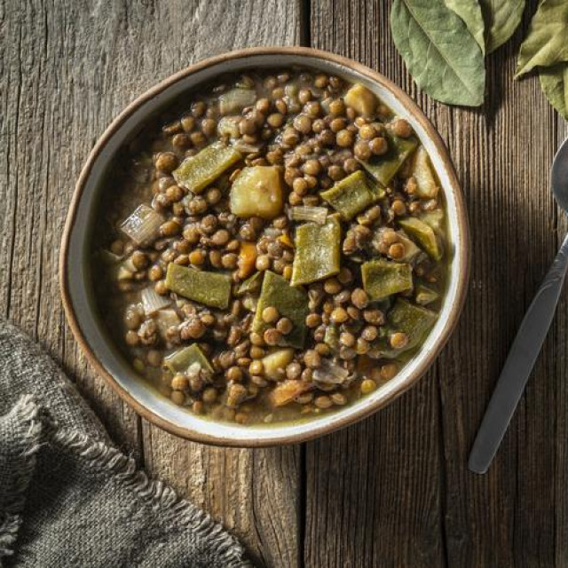 Brown Lentils vegan plant based recipe Mediterranean diet from Spain with ingredients as lentils, potato, carrot, zucchini, bay leaf, green beans, garlic, chili pepper, black pepper