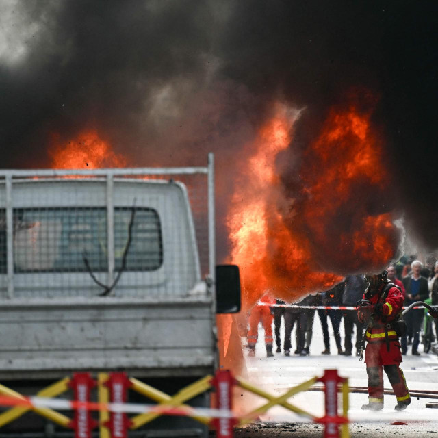 Firefighters try to extinguish a van on fire, at ”rue de Varenne” (Varenne street) in Paris, on October 7, 2025. (Photo by Bertrand GUAY/AFP)
