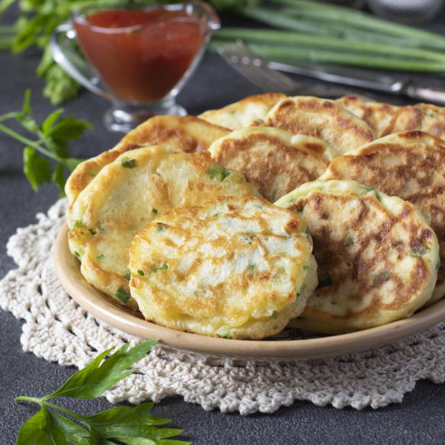 Fried fritters with green onion and cheese served for breakfast with ketchup