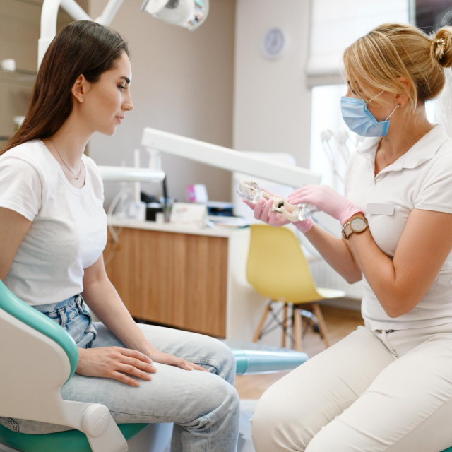 Female dentist and patient, appointment in clinic