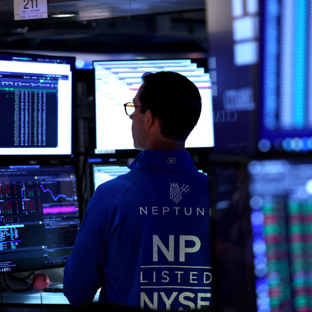 A trader works on the floor of the New York Stock Exchange (NYSE) at the opening bell on October 1, 2025, in New York City. Wall Street stocks mostly fell early Wednesday as the US government officially entered a partial shutdown following a stalemate in budget talks. (Photo by TIMOTHY A. CLARY/AFP)