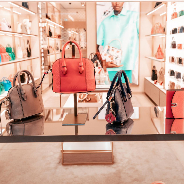 21 July 2022, Dusseldorf, Germany: Showcase of a fashion store or boutique with luxury Furla brand leather bags. Shopping and leisure concept