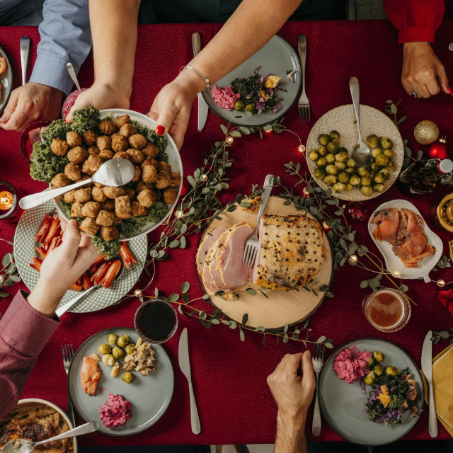 Typical swedish scandinavian christmas smörgåsbord buffet food Photo taken from above overhead table top shot Photot of typical smorgasbord with breaded ham, meatballs, sausauge,noisette, pickled herring and side dishes Julbord med griljerad skinka sill och lax