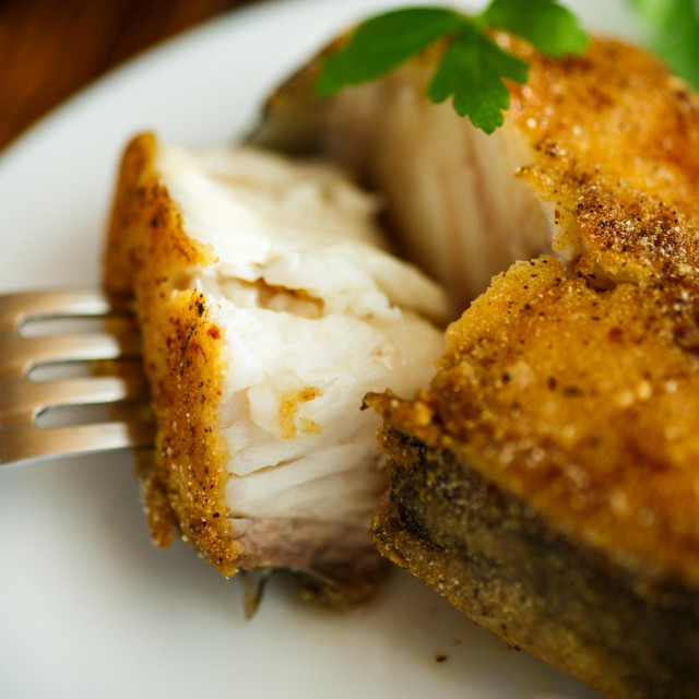 catfish roasted in batter on a wooden table