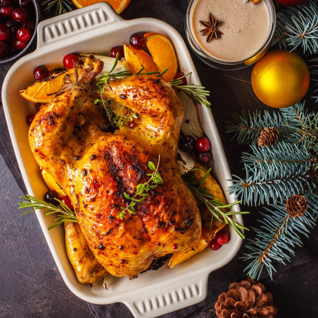 Christmas baked chicken with spices, orange and herbs. Christmas food concept.
