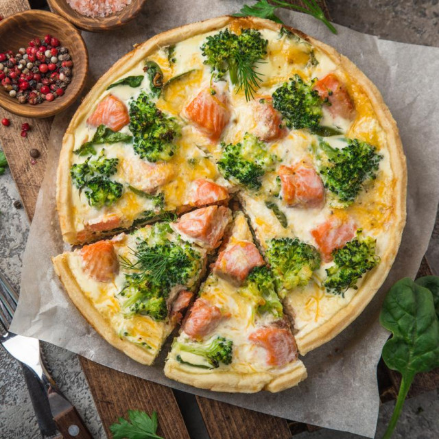 smoked salmon, broccoli and spinach quiche tart, top view, copy space