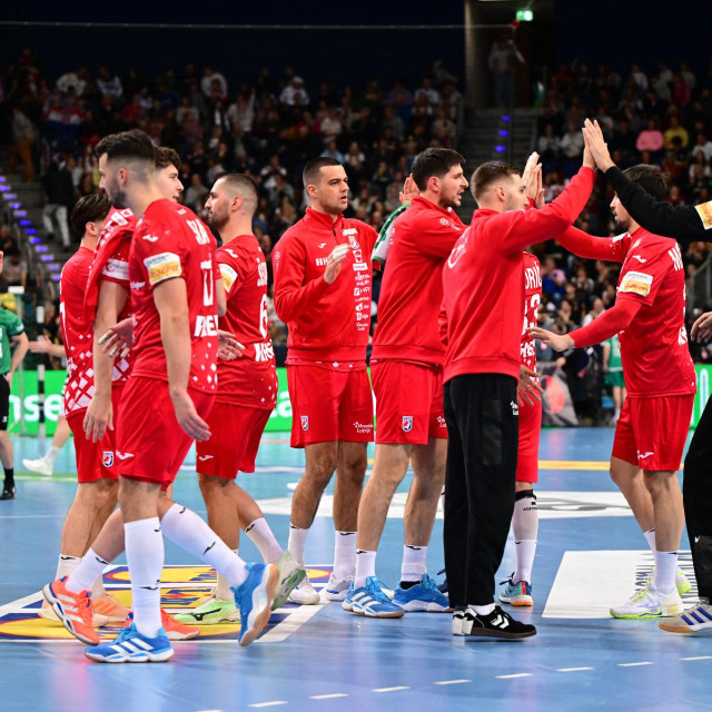 11 January 2026, Lower Saxony, Hanover: Handball: International match, Germany - Croatia, ZAG Arena. Croatia‘s players high-five each other. Photo: Sina Schuldt/dpa (Photo by Sina Schuldt/dpa Picture-Alliance via AFP)