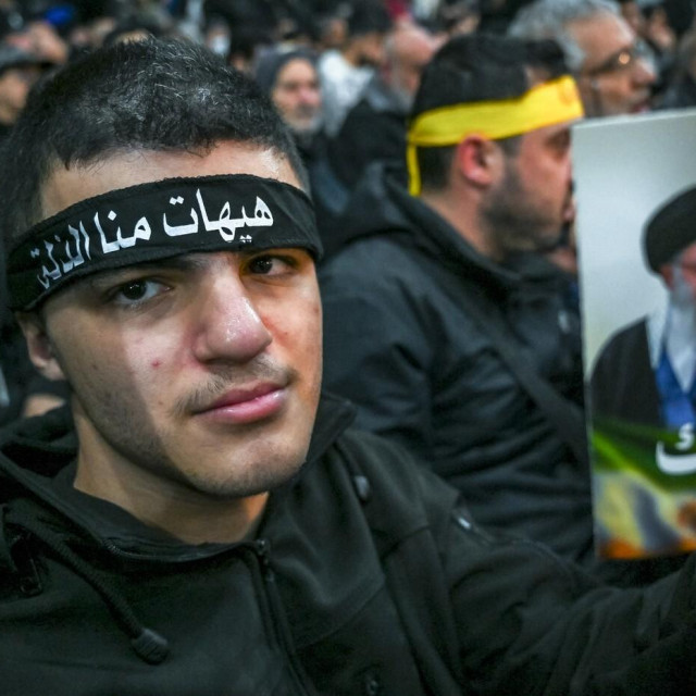 Pristalica Hezbollaha drži portret iranskog vrhovnog vođe ajatolaha Alija Hamneija tijekom skupa solidarnosti u južnim predgrađima Bejruta 26. siječnja 2026.