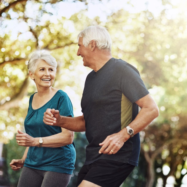 Running, outdoor and old couple with fitness, exercise and bonding together with challenge. Park, senior man and mature woman with training, retirement and hobby with sunshine, healthy and wellness