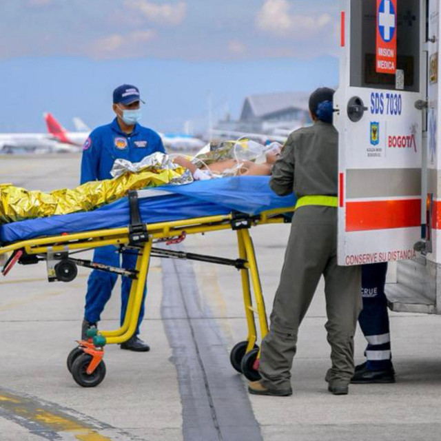 Fotografija iz priopćenja Kolumbijske oružane sile prikazuje pripadnike Kolumbijske svemirske sile i medicinsko osoblje kako nose ozlijeđenu osobu na vojnoj zrakoplovnoj bazi CATAM u Bogoti, 23. ožujka 2026., nakon pada vojnog zrakoplova Hercules C-130 kolumbijskog ratnog zrakoplovstva