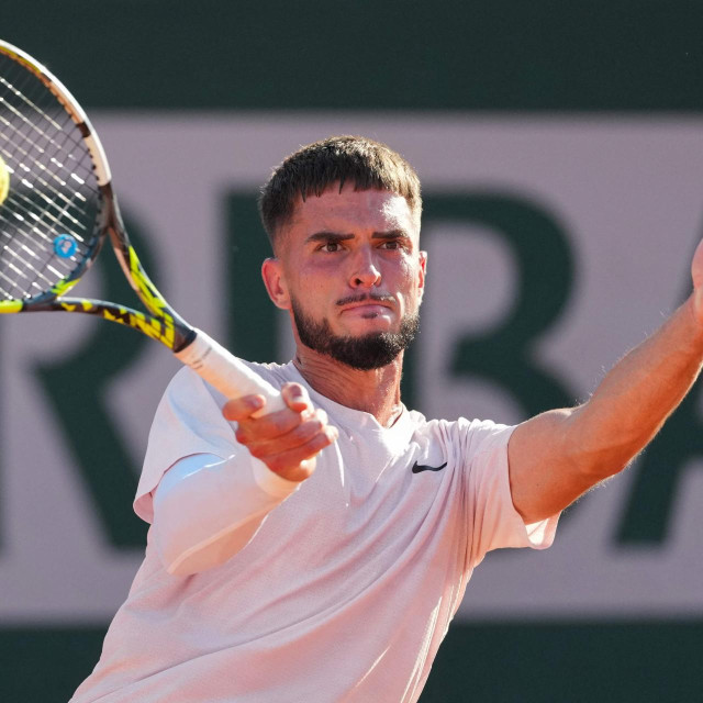 Croatia‘s Dino Prizmic plays a forehand return to Brazil‘s Joao Fonseca during their men‘s singles match on day 4 of the French Open tennis tournament at the Roland-Garros Complex in Paris on May 27, 2026. (Photo by Dimitar DILKOFF/AFP)
