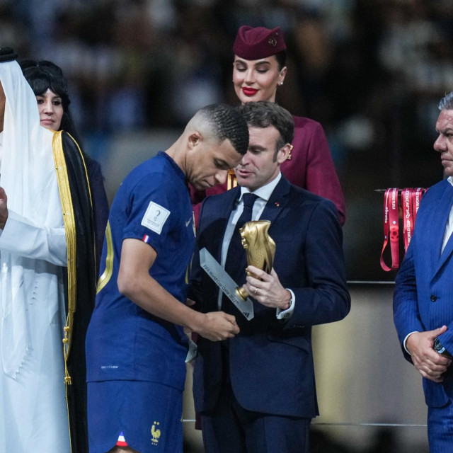 Francuski predsjednik Emmanuel Macron uručuje Kylianu Mbappeu nagradu za najboljeg strijelca na SP-u u Kataru 2022.