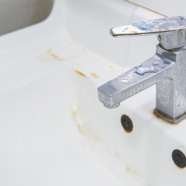 Dirty water tap and white ceramic sink with stains and plaque. step 1.