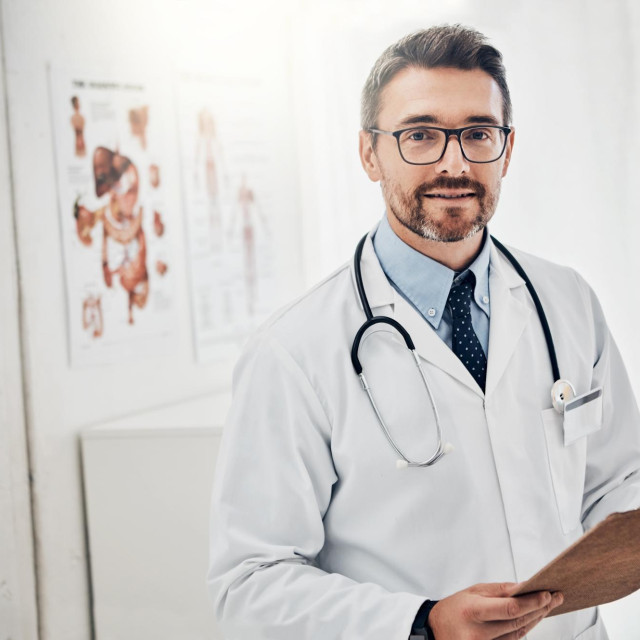 Portrait, man or doctor in office with clipboard, healthcare and confidence with hospital schedule. Admin, paperwork and medical professional with document, chart or application for health insurance