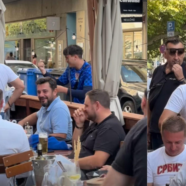 Hrvatski navijač u Munchenu pored skupine srpskih navijača
