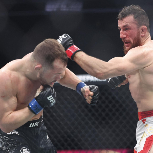 LAS VEGAS, NEVADA - DECEMBER 06: Merab Dvalishvili of Georgia (R) strikes Petr Yan of Russia during a bantamweight title fight during UFC 323 at T-Mobile Arena on December 06, 2025 in Las Vegas, Nevada. Ian Maule,Image: 1058604287, License: Rights-managed, Restrictions:, Model Release: no, Credit line: Ian Maule/Getty images/Profimedia