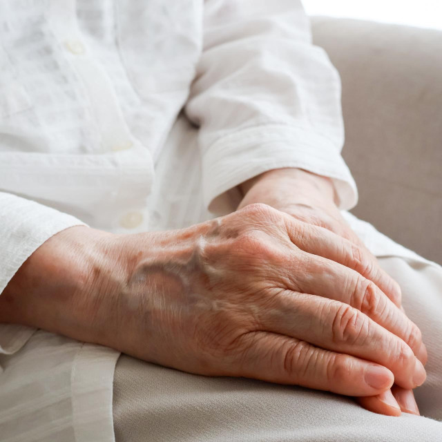 Close Up of Elderly Woman Hands Resting on Lap